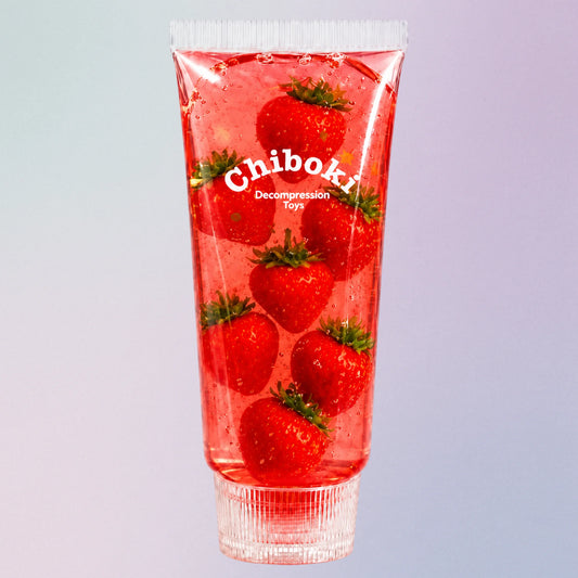 Red strawberry Chiboki toothpaste squishy, a jelly sensory toy with fruit pieces inside