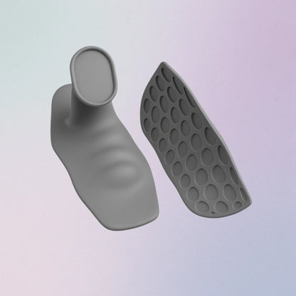 Gray silicone foot-shaped product with textured sole on a light purple background