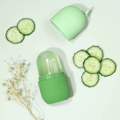 Green container with lid, sliced cucumbers, and dried flowers on a light background