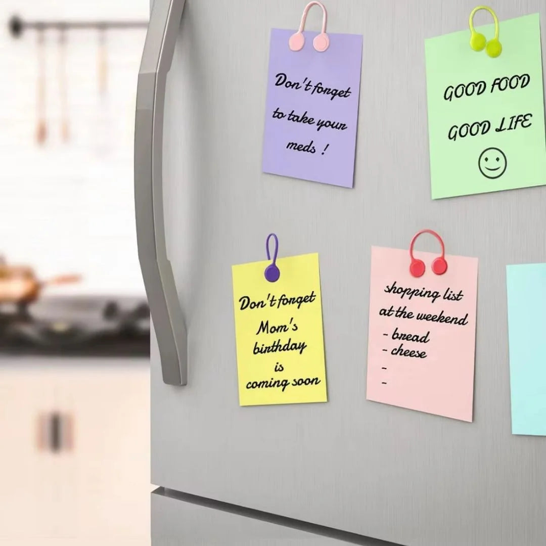 Colorful magnetic ties on a refrigerator door holding notes.