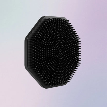 Black silicone face scrubber with soft bristles and finger grip