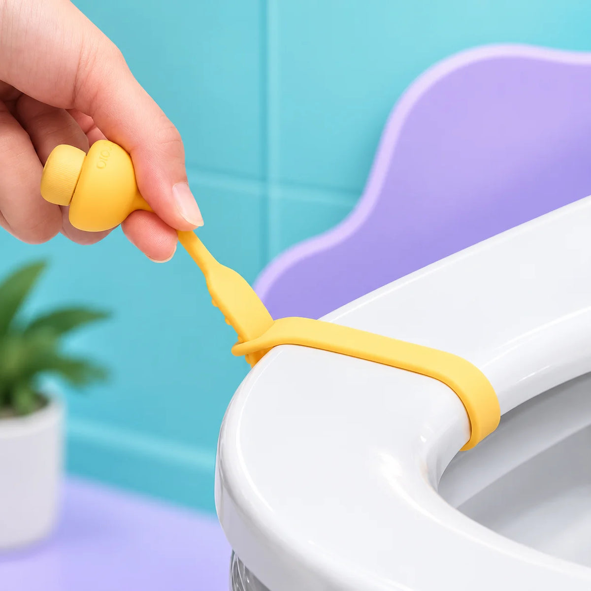 Close-up of a toilet seat lifter handle stuck under the seat